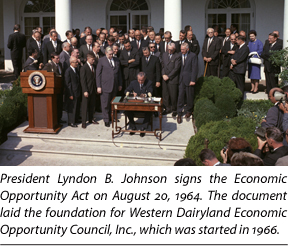 President Lyndon B. Johnson signs the Economic Opportunity Act of 1964